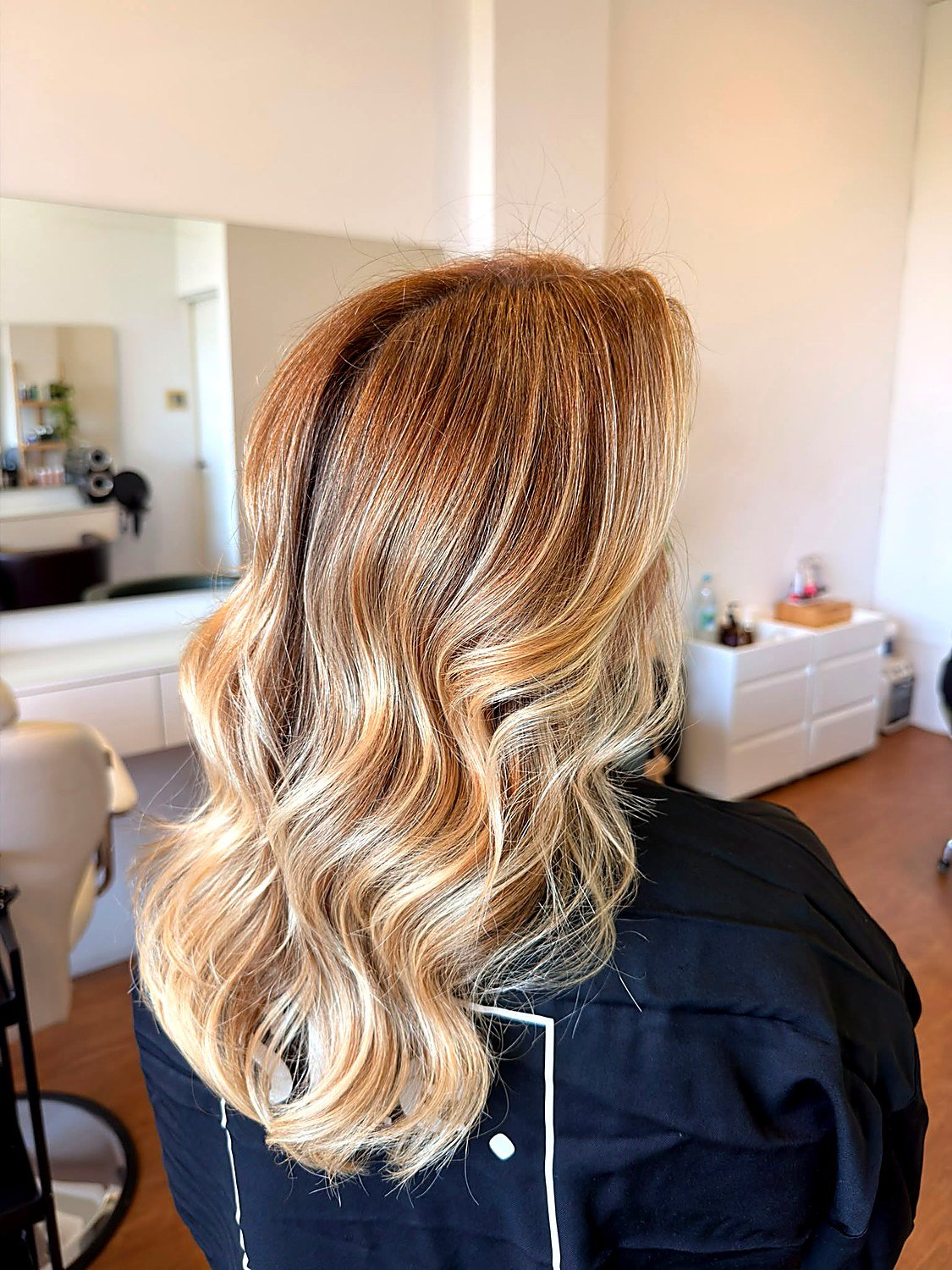 Golden blonde balayage with waves by the blonde specialists at She. Porto